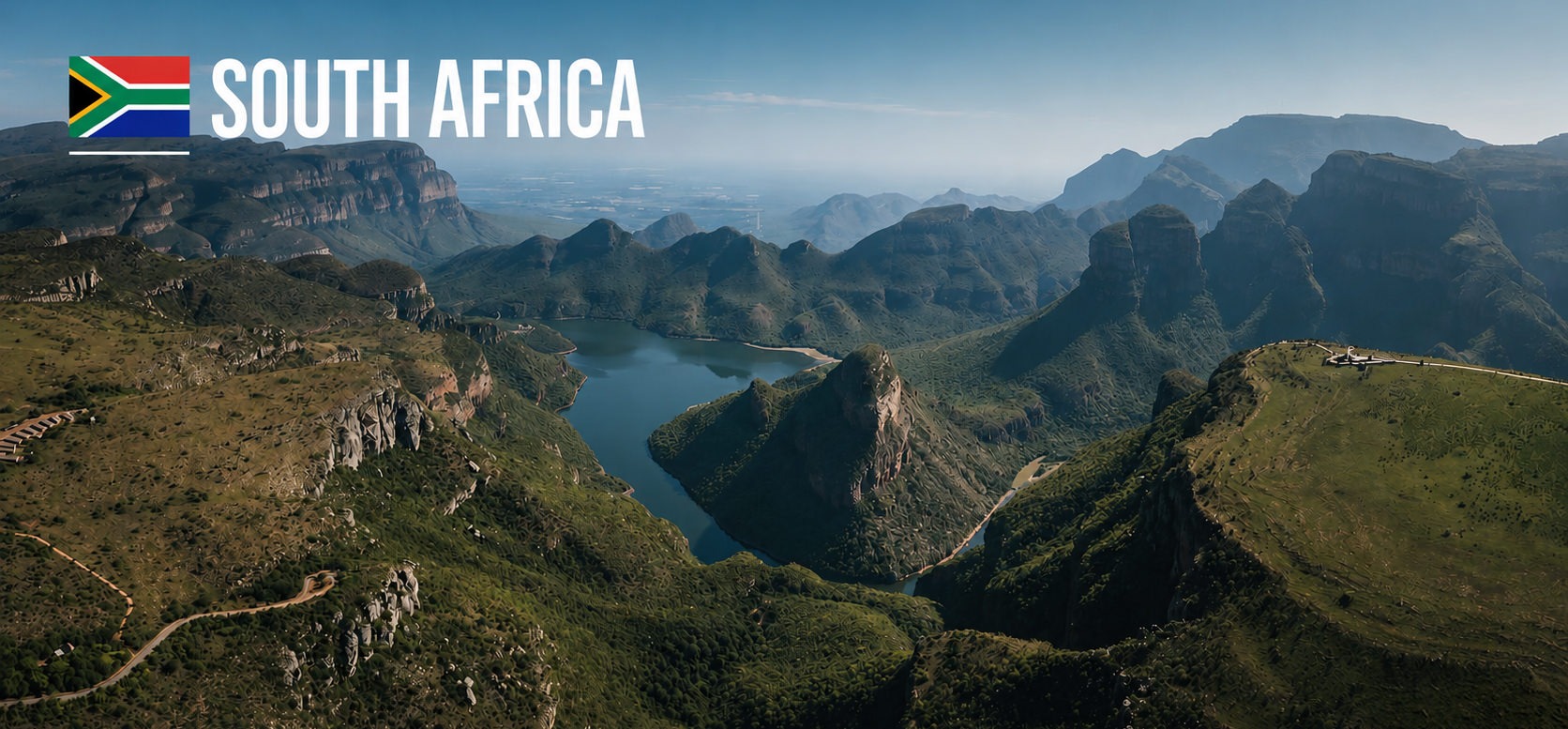 Panoramic view over the Blyde River Canyon in South Africa with steep mountain ridges, deep valleys and a winding river surrounded by dramatic landscapes.