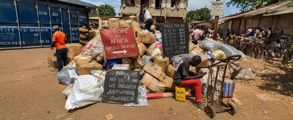 Large pile of parcels at an informal freight depot in Africa, illustrating an alternative shipping network for sending packages from Europe to destinations across the continent.