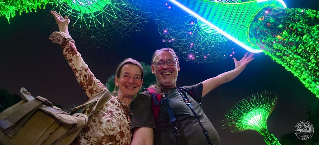 Totti and Fenny smiling beneath the illuminated Supertrees at Gardens by the Bay in Singapore